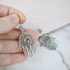 Handmade sterling silver filigree Hamsa earrings featuring Cherry Quartz