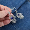 Symbolic handmade sterling silver Hamsa earrings with blue evil eye glass stone